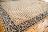 Vintage Mir Sarouk carpet corner, intricate navy blue border with pale tangerine accents and boteh field.