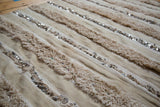 Moroccan handira wedding blanket's alternating ivory shaggy texture with plain weave and silver sequins.