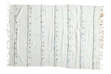 Ivory hand-woven Moroccan Handira wedding blanket with textured strips and metal sequins.