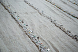 Alternating ivory pile and plain weave texture with playful metal sequins on a handira.