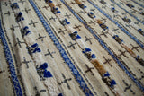 Alternating thick piled texture, cobalt blue patterns, and silver sequins on vintage wedding blanket.
