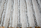 Detail of ivory Moroccan wedding blanket showing alternating pile and plain weave with silver sequins.