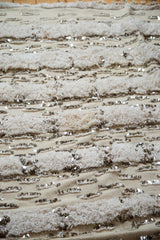 Alternating plain weave and thick piled ivory texture on wedding blanket, with silver sequins.