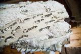 Ivory vintage wedding blanket (handira) with thick pile texture and shimmering silver sequins.