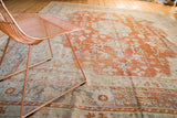 Oushak carpet border, rust orange and pale blue-gray geometric and floral motifs on ivory.