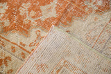 Vintage Oushak rug corner showing rust orange pile and tightly woven back.
