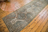 Distressed Kars runner, oversized repeating geometric medallions in ivory and celadon.