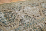 Distressed Kars runner with faded ivory, blue, and brown intricate geometric patterns.