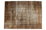Distressed Vintage Sivas Carpet with allover floral and vine design in antique ivory wooded tones.