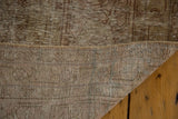 Hand-knotted foundation and textured distressed pile of a vintage Oushak rug, with secure edges.