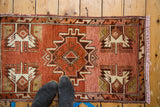 Vintage Oushak rug mat with rust, rose, ivory serrated medallion, abrashed field, feet.