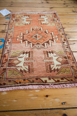 Vintage Oushak rug's lower corner, displaying serrated geometric motifs, rust field, and short fringe.