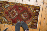 Vintage Oushak rug corner, showing playful saffron yellow star border and geometric hook-motif.
