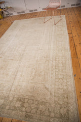 Vintage Oushak carpet corner with ivory, beige field and sage geometric floral border.