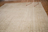 Vintage Oushak carpet with subtle ivory, beige, and sage gold patterns on its field and border.