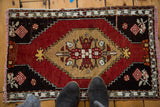 Vintage Oushak rug with scalloped medallion, floral design, and checkered lily spandrels.