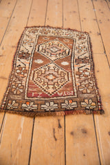 Irregular edge and fringe of a vintage Oushak rug's geometric border in bronze and beige.