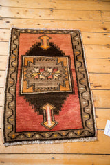 Hand knotted Oushak rug corner with rust orange field, serrated arrow motif, and coffee brown meandering border.