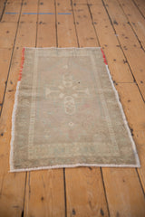 Unique red and orange weft detail on vintage Oushak rug with muted geometric pattern.
