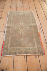Vintage Oushak rug with central geometric medallion pattern in pale mauve and celadon.