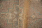 Vintage Oushak rug pile detail, showing textured weave and celadon geometric pattern.