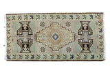 Vintage Oushak rug mat, geometric medallion with potted plants, ivory, green, and blue.