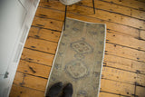 Vintage 1940s Oushak rug mat showcasing celadon green abrash and serrated diamond medallions.
