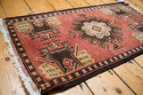 Vintage Oushak rug's bold center medallion with germinating plant and vase motif.