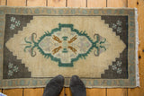 Vintage Oushak rug, ivory field, curvilinear-geometric medallion, charcoal spandrels, teal and mauve.
