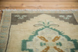 Hand-knotted vintage Oushak rug pile, fringe, and teal, caramel, charcoal, ivory patterns.