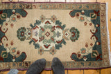 Oushak rug's elegant hand-knotted central medallion with sea foam green, teal, and purple motifs.
