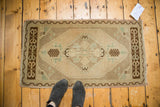 Vintage Oushak rug with geometric diamond medallion, corner spandrels, and zig-zag border.