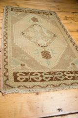 Vintage Oushak rug detail showing the meandering zig-zag border and fringe.