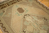 Vintage Oushak rug detail: beige open field with geometric diamond motif, celadon, and coffee brown.