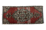 Vintage Oushak rug with large central medallion and abrashed dusty rose red field.