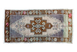 Hand knotted vintage Oushak rug mat, beige rams horn medallion, pink and green floral border.