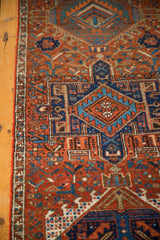 Traditional Karaja runner with brick red, navy, and teal geometric gul motifs and border detail.