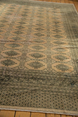 Geometric Turkmen design on the distressed blanched pink ivory Pakistani rug border.