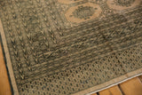Distressed Turkmen geometric pattern in blanched pink ivory and dark tones.