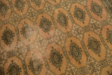 Distressed blanched pink ivory pile showing faded texture and dark Turkmen patterns.