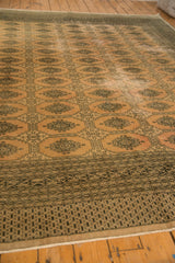 Distressed end border with dark geometric design and short ivory fringe.