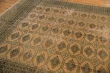 Distressed vintage Pakistan carpet: blanched pink ivory field, dark Turkmen guls.