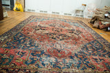 Vintage distressed Heriz carpet with striking cherry red and sapphire blue medallion.
