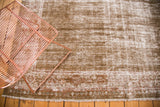 Vintage Mahal carpet end with distressed green-brown pile, ivory foundation, and red border.