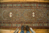Geometric Serab medallions with blue mehrab niches on a camel hair and terracotta field.