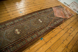 Vintage Serab runner rug with geometric medallions in camel, madder red, and blue.
