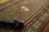 Intricate geometric motifs on a vintage Serab runner with camel, terracotta, and blue.