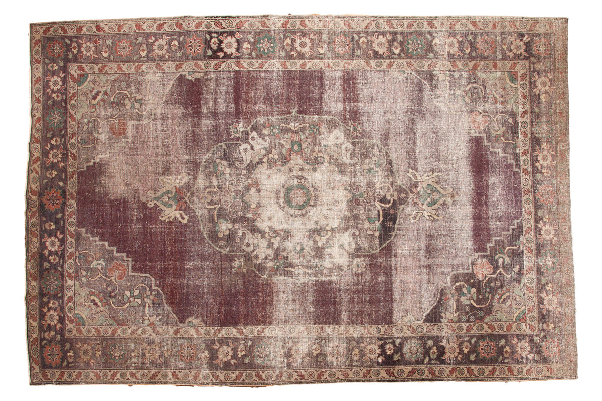 Distressed vintage Oushak carpet in unique violet purple with faded medallion design.