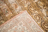 Close-up of distressed Qom rug pile, contrasting with clear hand-knotted allover vines on back.