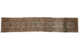 Vintage Persian hand-knotted Serab runner with repeating geometric diamond medallions in antiqued tones.